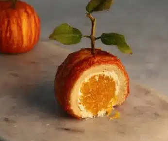 baked-orange-shaped-pastry-cross-section Baked orange shaped pastry with visible citrus center and pastry crust