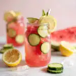 Watermelon cucumber lemon water in glass pitcher with lemon and mint