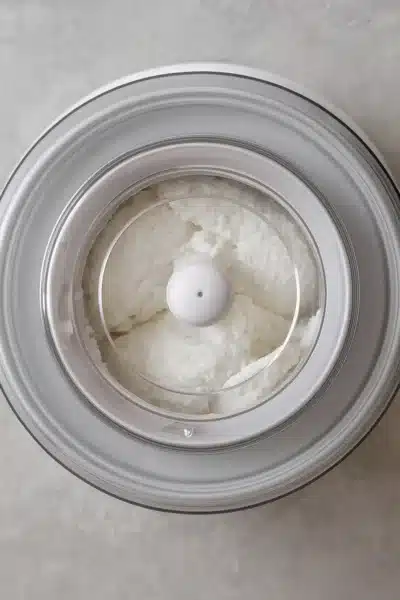 Churning coconut sorbet in ice cream maker – coconut sorbet in shell