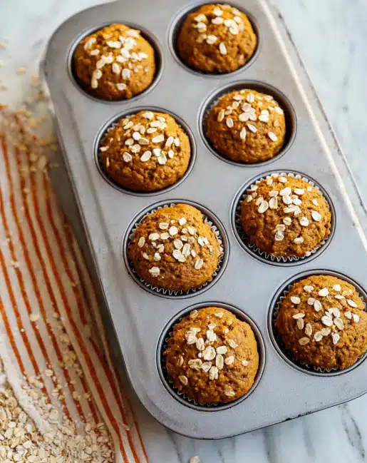 Healthy maple pumpkin muffins fresh out of the oven in a baking tray