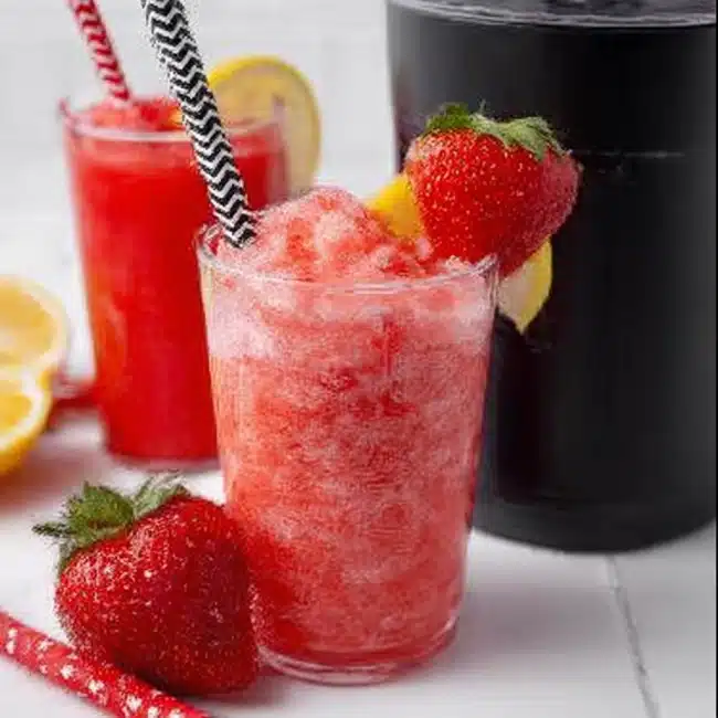 Ninja Creami slushie recipe served with fresh strawberries in a glass