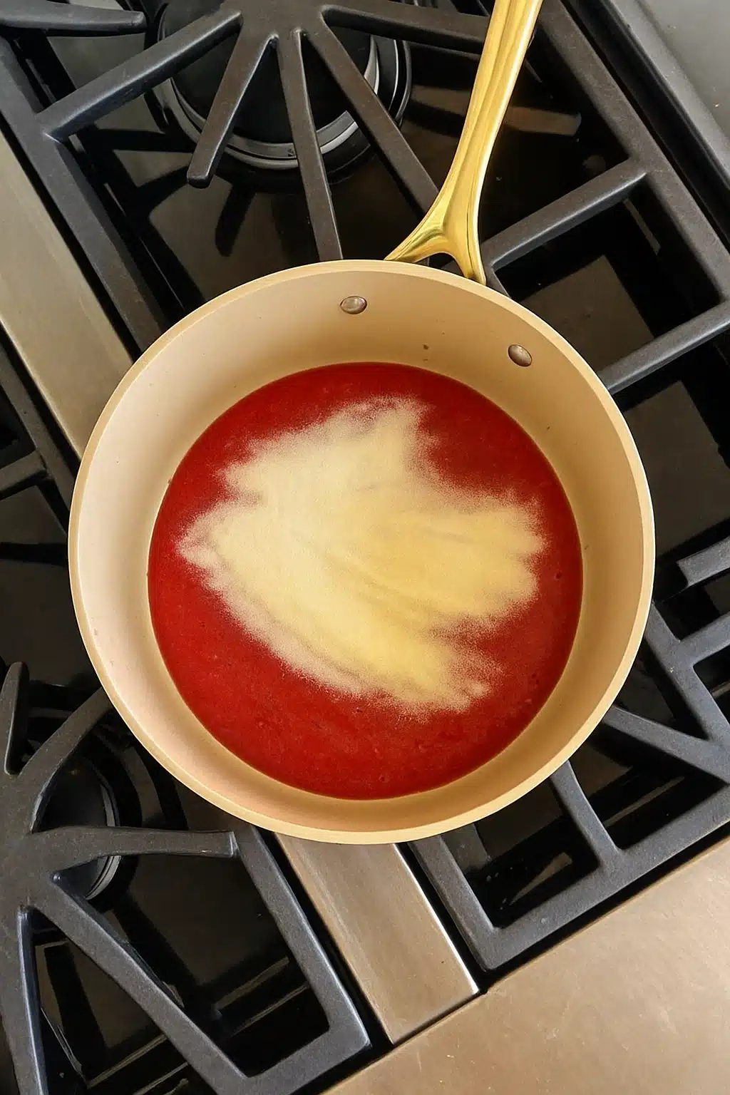 Adding gelatin to strawberry mixture for homemade strawberry gummies