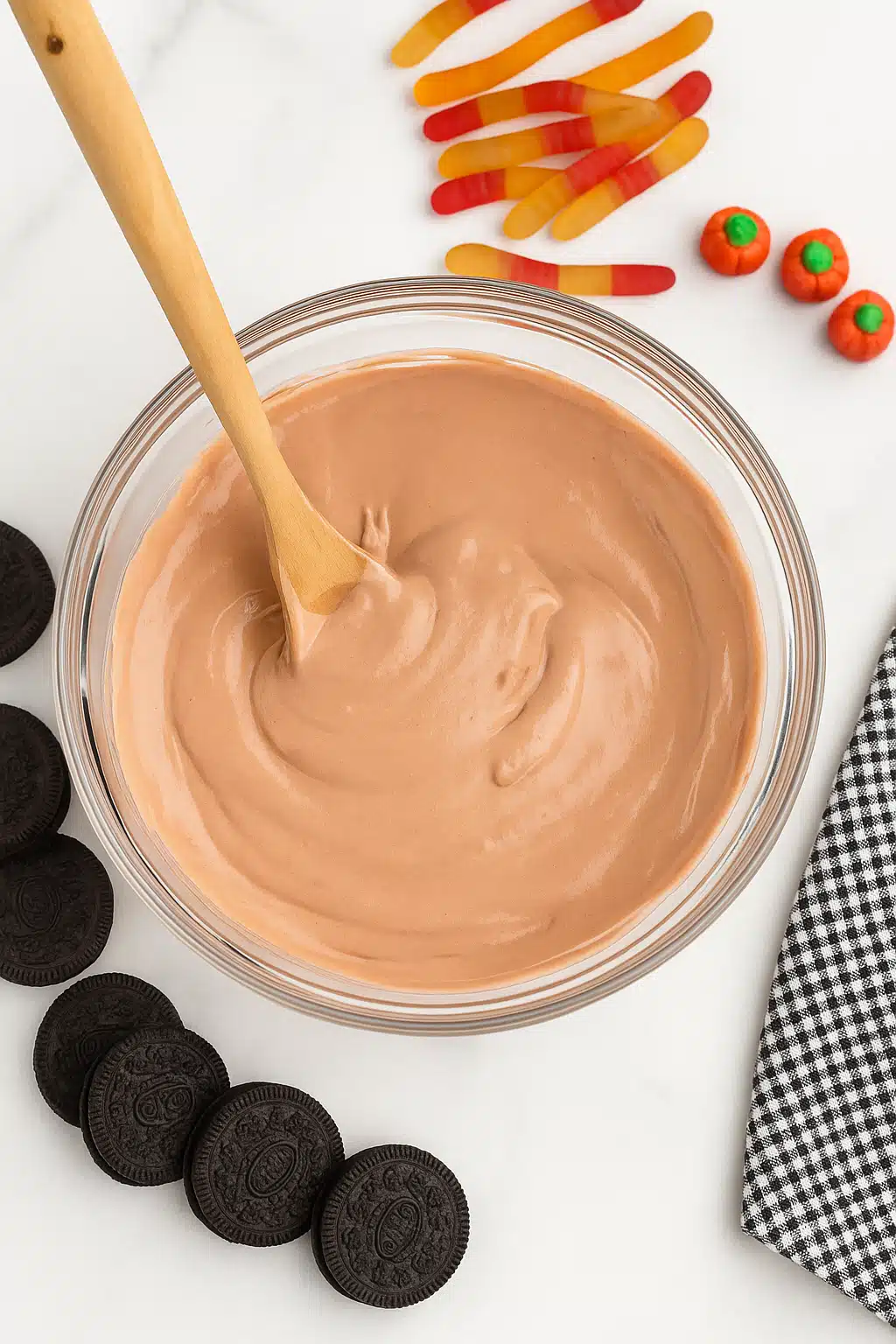 Folding whipped topping into pudding mixture for Halloween Dirt Cups