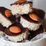 healthy almond joys stacked on wooden board