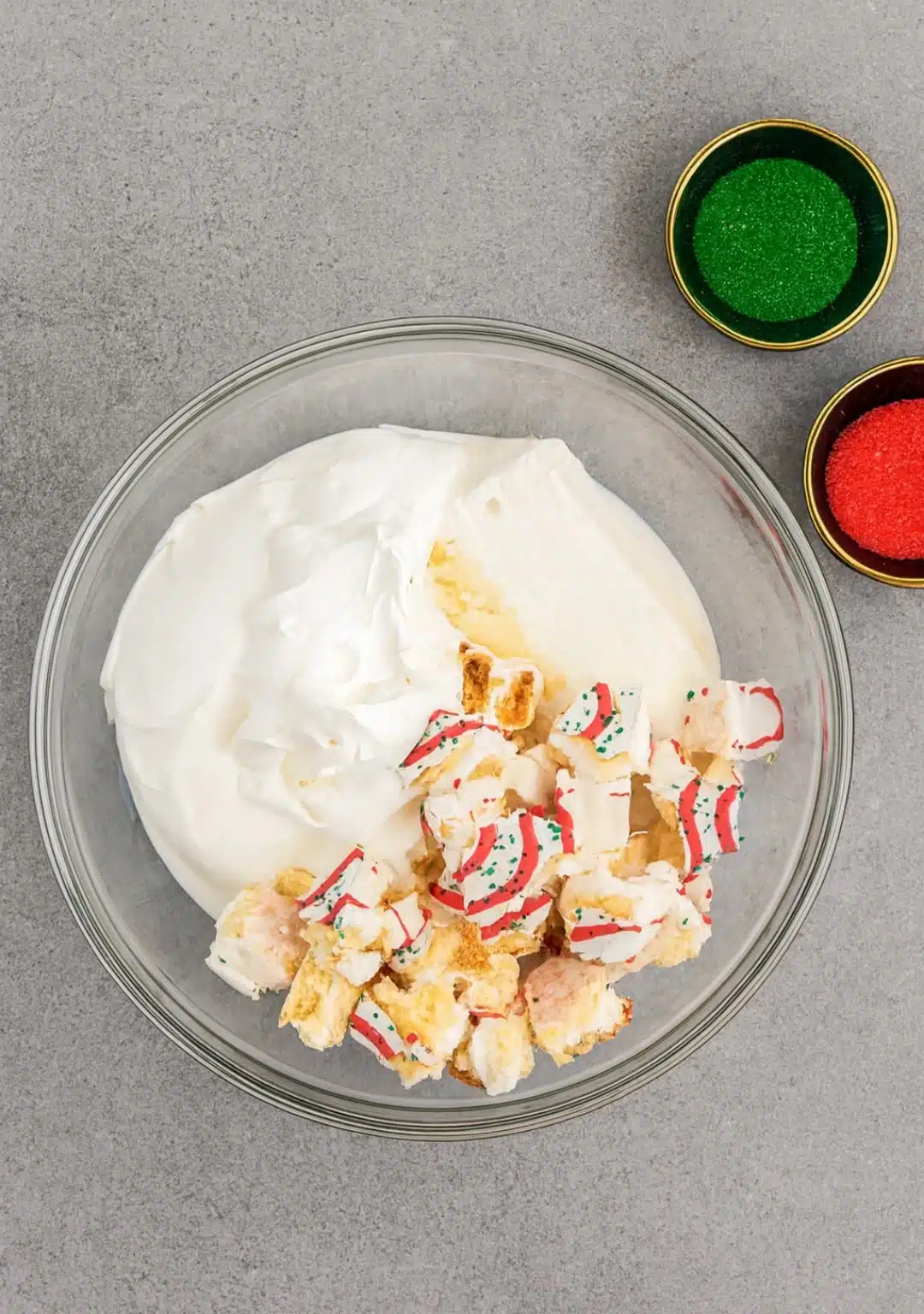 Mixing whipped topping and chopped Little Debbie Christmas Tree Cakes in a bowl for Christmas Tree Dip