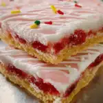 Strawberry Pop Tart Cookie Bars with pink glaze and sprinkles