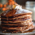 Gingerbread Pancakes Recipe 6 Fluffy gingerbread pancakes served with syrup and whipped cream.